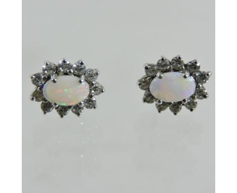 A pair of silver opal and gem set stud earrings, cased