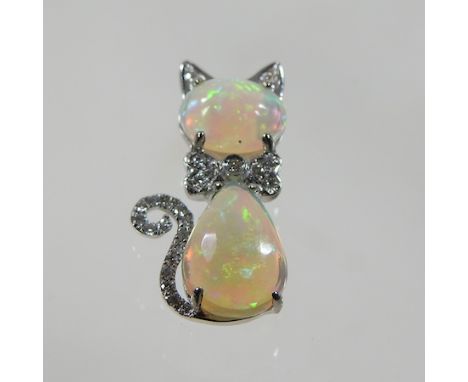 A 14 carat white gold and opal pendant, in the form of a cat, 2cm high