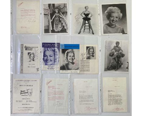 A lever arch file with 12 signed items by Betty Grable - programmes and photos.