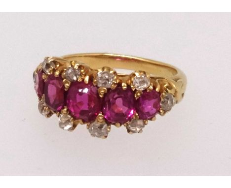 A fine five stone ruby and diamond ring set in yellow gold, finger size O.