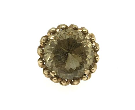 A large smokey quartz high set gold ring, (believed to be 14k set), weight 16.40gms, finger size R.