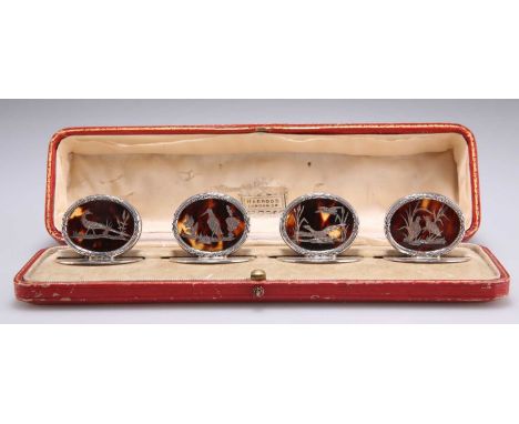 A SET OF FOUR GEORGE V SILVER AND TORTOISESHELL MENU HOLDERS by William Comyns &amp; Sons, London 1913, each with an oval piq
