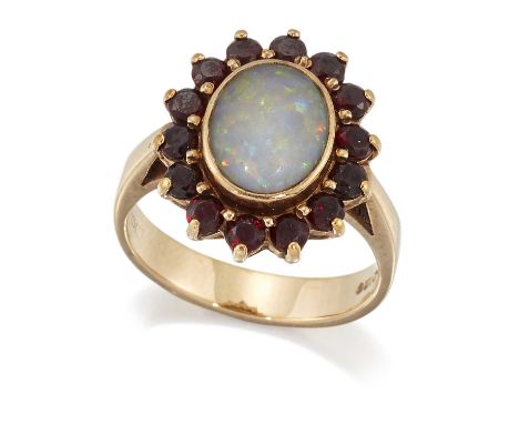 A 9 CARAT GOLD OPAL AND GARNET CLUSTER RING an oval opal within a border of round-cut garnets. Hallmarked Birmingham, ring si