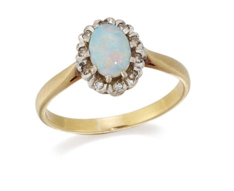 AN OPAL AND DIAMOND CLUSTER RING an oval opal within a border of illusion-set diamonds. Ring size N1/2, 3.10 gramsGood condit