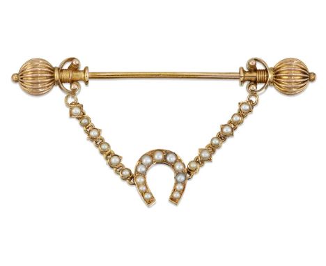 AN EARLY 20TH CENTURY SEED PEARL JABOT PIN the pin with reeded pommel ends and suspending a horseshoe from fancy seed pearl-s