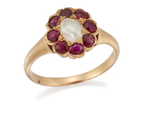 A SPLIT PEARL AND RUBY CLUSTER RING a split pearl within a border of round and oval-cut rubies, to a tapering shank. Ring siz