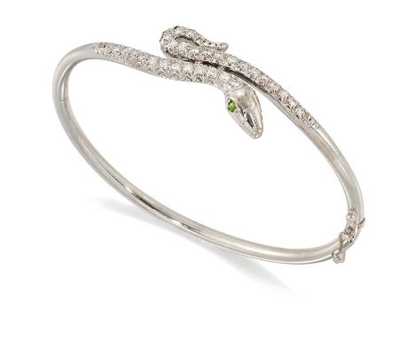 A DIAMOND HINGE OPENING SNAKE BANGLE a coiled snake pavé-set with round brilliant-cut diamonds and with green gem-set eyes. E