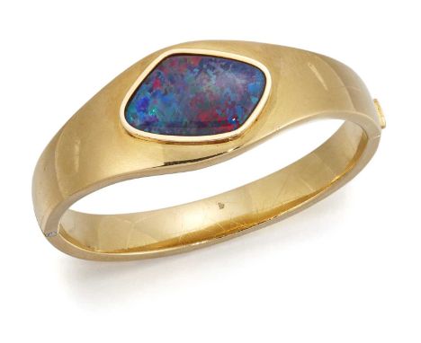 AN OPAL HINGE OPENING BANGLE an opal plaque set within a tapering bangle. Marked '750', 5.2cm by 6cm inner diameter, 2.4cm wi