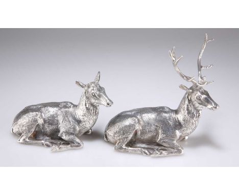 A PAIR OF CONTEMPORARY SILVER TABLE DECORATIONS by James R Biggins, Sheffield 2022, cast as a recumbent stag and hind. (2) St