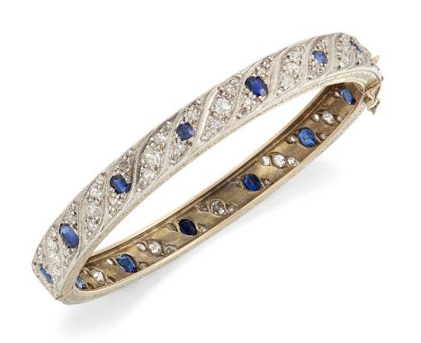 AN EARLY 20TH CENTURY SAPPHIRE AND DIAMOND HINGE OPENING BANGLE groups of oval-cut sapphires and old-cut and rose-cut diamond