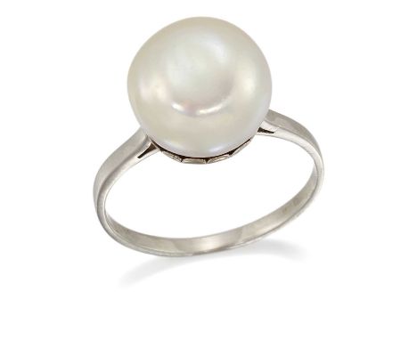 A CULTURED BUTTON PEARL RING Ring size L1/2, 4.1 gramsThe pearl is of pink-green lustre with a slightly concave shape. 11.40m