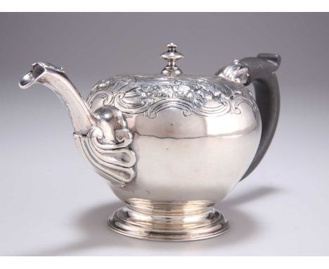 A GEORGE II SILVER TEAPOT by Samuel Woods, London 1746, bullet form, with scroll handle, leaf-capped spout, chased with folia