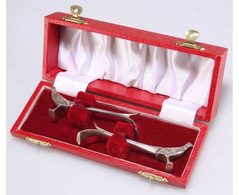 A PAIR OF ELIZABETH II SILVER KNIFE RESTS by Bishton's Ltd, Sheffield 1977, in the form of stylised pheasants, cased. 9cm lon