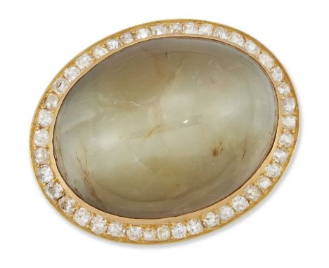 A LARGE CAT'S EYE CHRYSOBERYL AND DIAMOND BROOCH an oval cat's eye chrysoberyl within a border of old-cut diamonds. Estimated