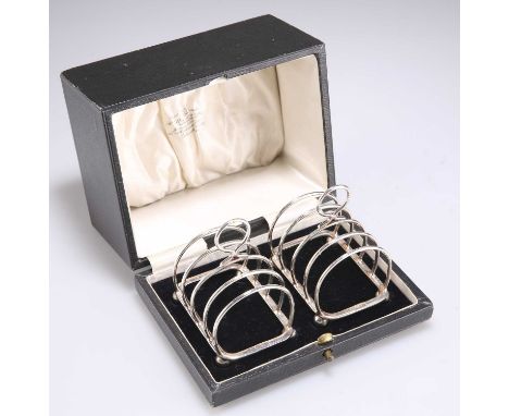 A PAIR OF GEORGE V SILVER TOAST RACKS by Atkin Brothers, Sheffield 1930 and 1931, of five-bar design, in a fitted box. 7cm wi