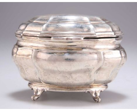 A VICTORIAN SILVER CADDY by Charles Stuart Harris, London 1899, of bombe form with a hinged cover and four scroll feet. 13cm 