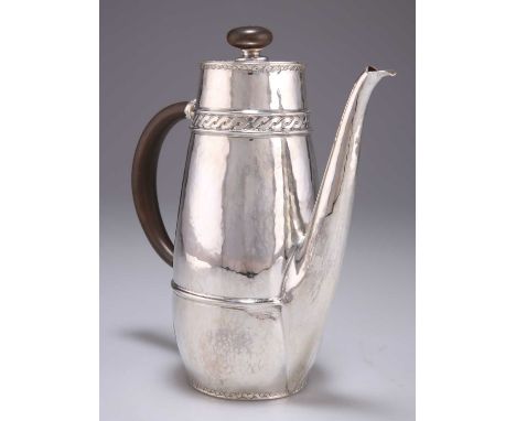 AN ARTS AND CRAFTS SILVER COFFEE POT by W H Haseler Ltd, Birmingham 1911, possibly for Liberty &amp; Co, the spot-hammered gr