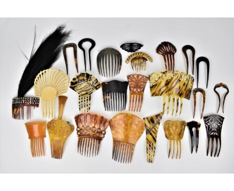 A collection of early 20th century faux and real tortoiseshell hair combs, comprising mantilla combs, an ivory comb, a tortoi