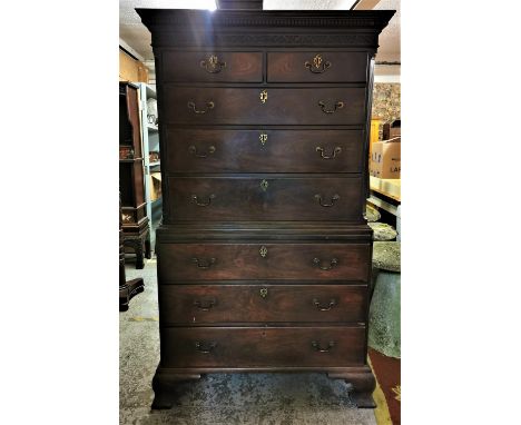 A late Georgian mahogany chest on chest, with moulded dentil cornice above a carved fretwork frieze, the drawers with pierce 