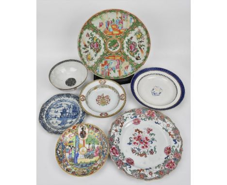 An 18th century Chinese export armorial porcelain shallow bowl, with finely detailed central crest, small vignettes with hors