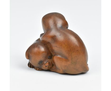 A Japanese carved wood netsuke, 19th century, modelled as two puppies, unsigned, 3 cm high x 3.5 cm wideCondition report: one