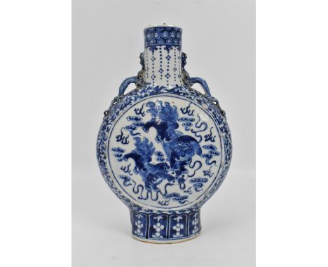 A late Qing dynasty blue and white porcelain moon flask vase, with central panels either side depicting guardian foo dogs wit