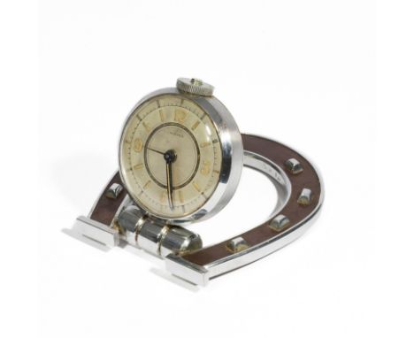 HERMES Paris, circa 1959. Pendulette de voyage Fer à Cheval.En acier chromé partiellement recouvert de cuir brun, cadran arti