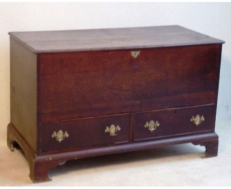 An 18th Century oak Mule Chest, the two plank top with outer moulding opening to reveal cupboard space and over two lover hal