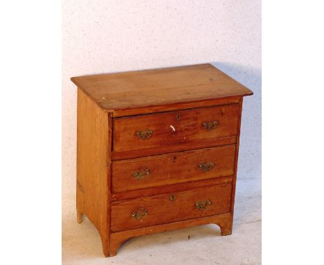 A miniature late 19th Century three drawer pine Chest on bracket feet, 49cm wide 