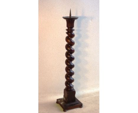 A large stained wood (probably oak) Pricket Stick, the circular top with cast iron spike above carved 'stiff leaf' decoration