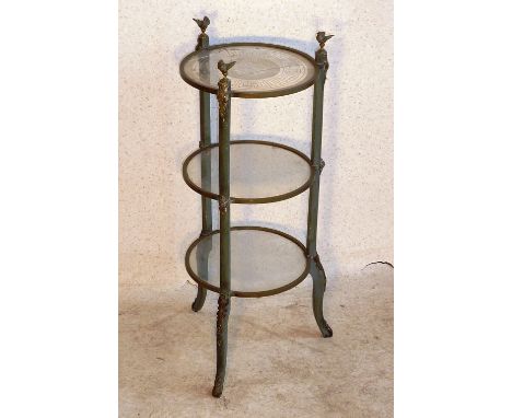 A French Empire period three tier circular Etagere, three open winged bird finials above three glass shelves (the top shelf e