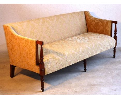 An early 19th Century Regency period cream upholstered and mahogany show wood Sofa of large proportions, the two handles reed