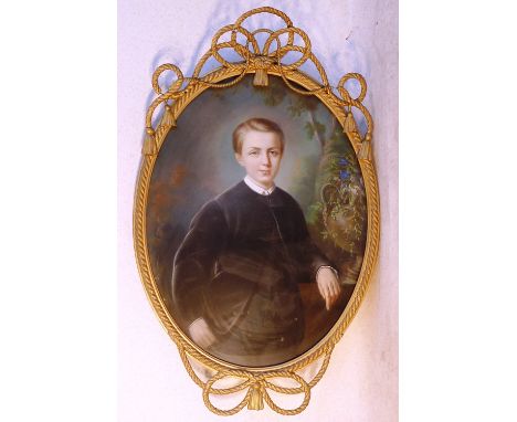 A 19th Century oval gilt framed and glazed half length Portrait Study (probably Pastel) of a young boy in black tunic and wai