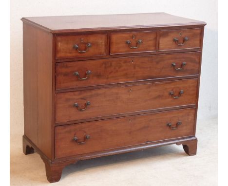 A George III period late 18th Century mahogany Chest, the thumbnail moulded top above an arrangement of three short drawers a