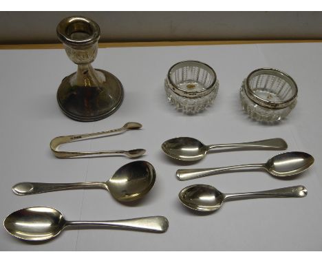 A silver Dressing Table Candlestick, a pair of glass Salts with silver rims, four various silver Teaspoons, silver Sugar Tong