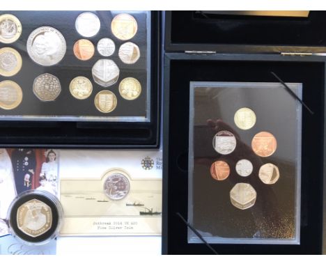 A Royal Mint 2011 Proof Set with Cardiff and Edinburgh £1 coins, a 2008 Proof Set, a Silver Proof 2014 £20 commemorating the 