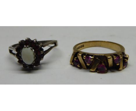 A 9ct gold Dress Ring of modern design set with rubies, and a silver gilt opal and garnet Ring.