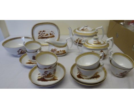 An early 19th Century English Tea Set decorated with landscape panels within a gilt border comprising eight cups in two sizes