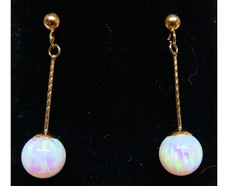 A pair of 9ct. gold pendant Earrings each set with a single opal. 