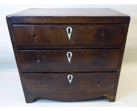 A miniature 19th Century mahogany Chest of three long Drawers with ivory key plates and shaped apron and bracket feet.  10" (