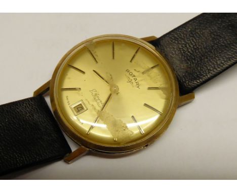 A Gentleman's Rotary Wristwatch with baton numerals and date aperture in a 9ct gold case with inscription.