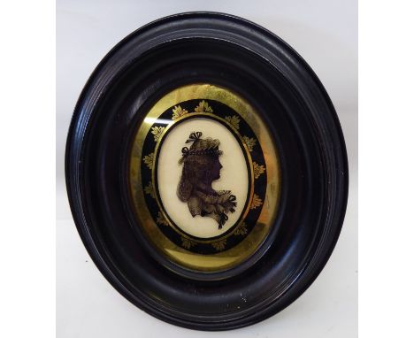 Attributed to ISABELLA BEETHAM; A reverse painted Silhouette on glass of a lady with a bandeau in her hair in verre eglomise 