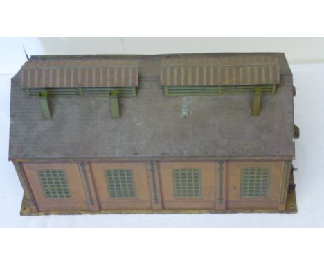 A Hornby 'O' gauge Twin Engine Shed of brick work design, 18" (46cms) long, circa 1930s, one door and five chimneys missing, 