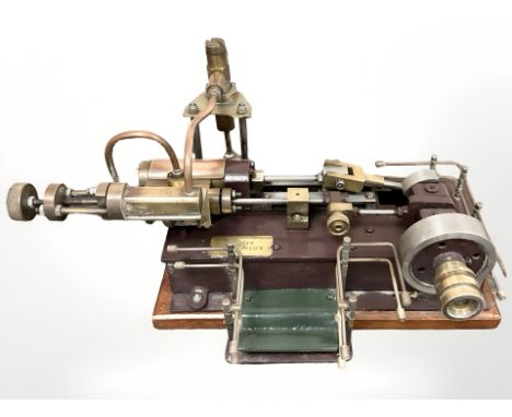 A live steam stationary engine, with brass inset plaque marked A Urwin, Bedlington, width 31cm, together with a related volum