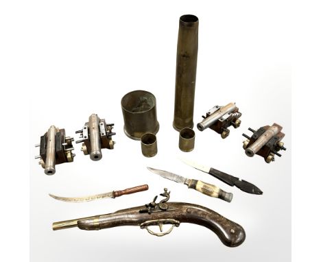 A group of four miniature metal desk cannons on wooden carriages, four inert brass shells, a replica pistol, a hunting knife 