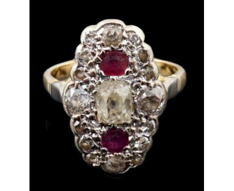 An 18ct gold ruby and diamond cluster ring, the central old mine cut diamond flanked by two rubies and bordered with small co