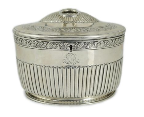 A George III demi fluted silver oval tea caddy by Andrew Fogelberg &amp; Stephen Gilbert, with engraved monogram, the hinged 