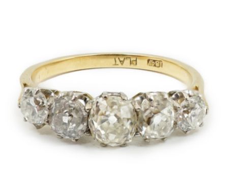 An early to mid 20th century 18ct gold, platinum and graduated five diamond set half hoop ring, the central stone diameter ap