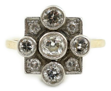 A 1920's/1930's 18ct gold, platinum and millegrain set nine stone diamond cluster ring, the central stone diameter approximat