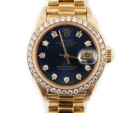 A lady's 1990 18ct gold and diamond set Rolex Oyster Perpetual Datejust wrist watch, the blue dial with diamond dot markers a